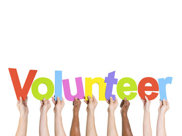 hands raised holding letters