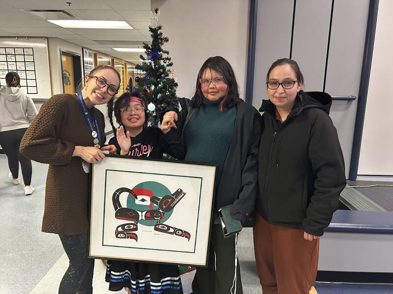 our staff being presented with an original art piece from the Silver family