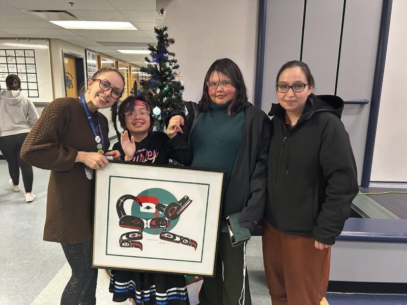 our staff being presented with an original art piece from the Silver family