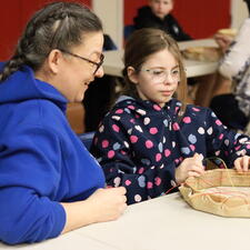 Indigenous Support Worker supporting student with drum making