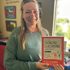 Staff member holds up a book titled "Thinking Classrooms"